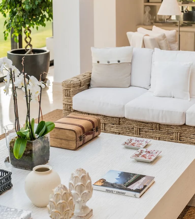 Natural-textured living area with woven sofa and garden views at Villa El Olivo, Marbella