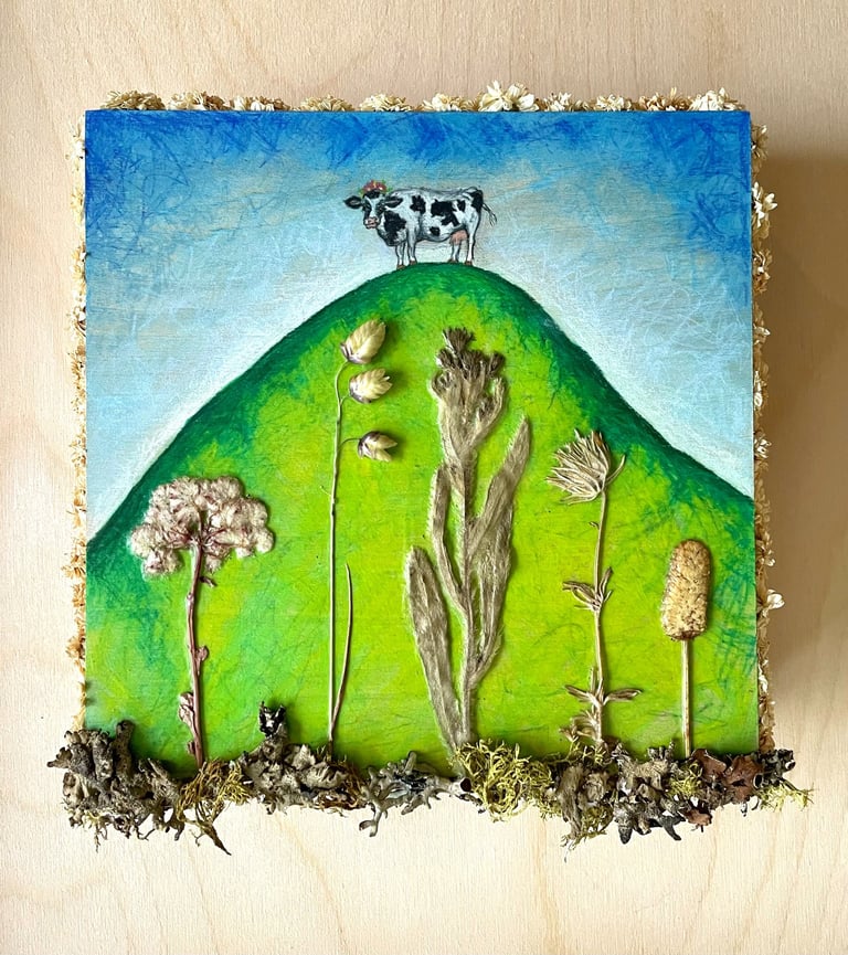a painting of a cow on a hill with pressed flowers