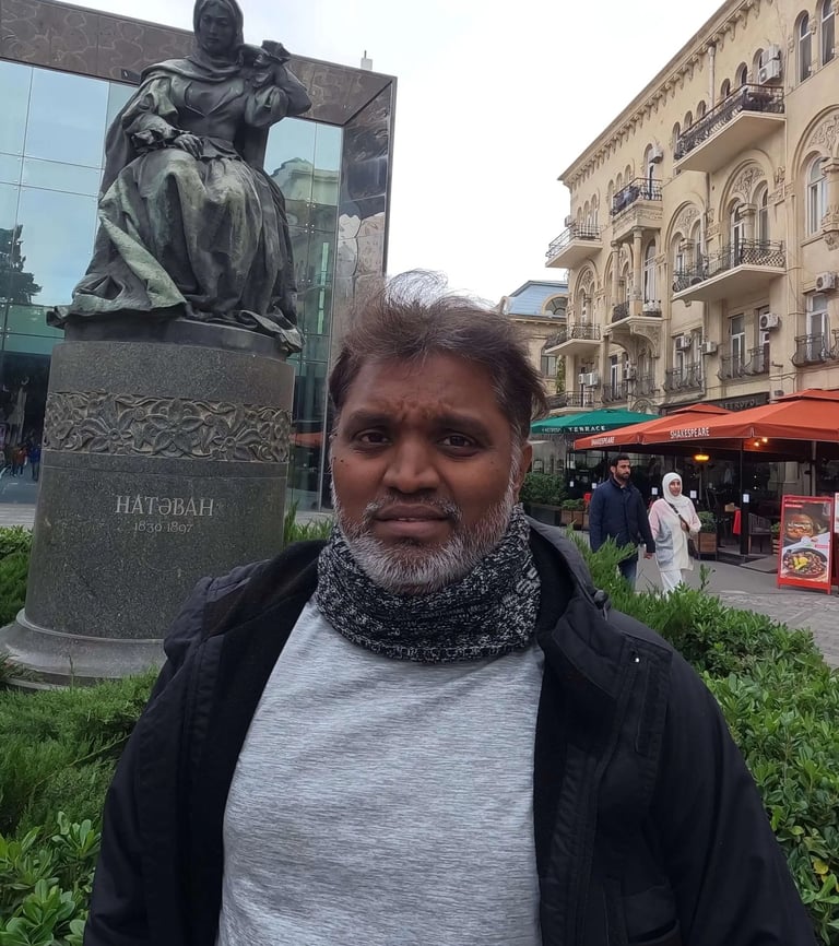 a man standing in front of a statue of a man