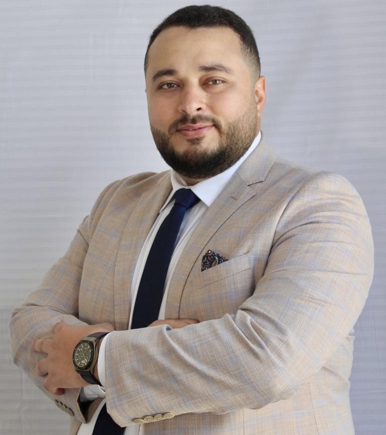 a man in a suit and tie with a watch on his wrist