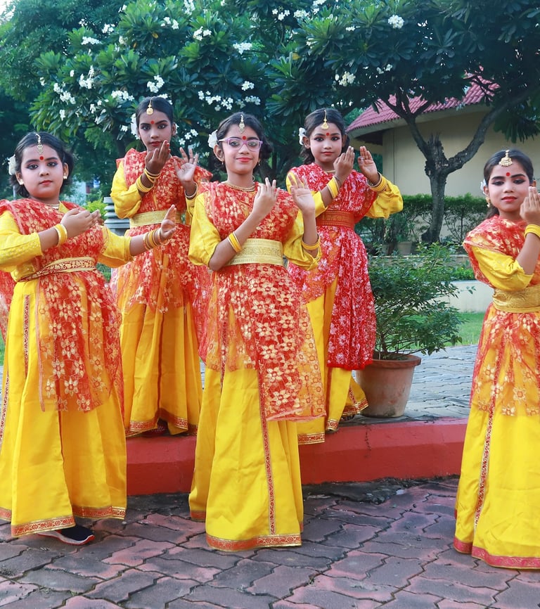 A group of girls in traditional attire showcasing a synchronized folk dance during the annual functi