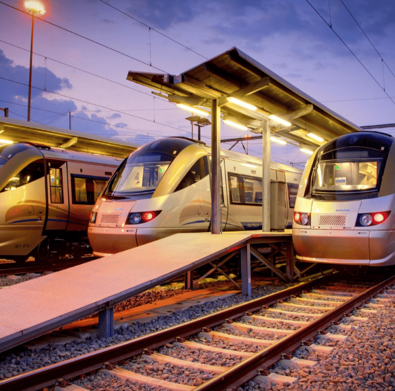 two trains parked at a train station