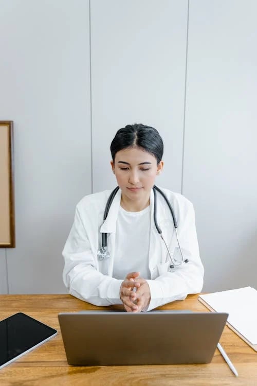a woman in a white lab coat and a stethrobe