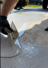 a person is doing epoxy work on a concrete floor