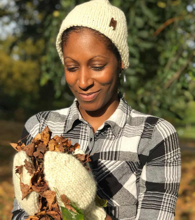 a woman wearing a knitted hat and mittens