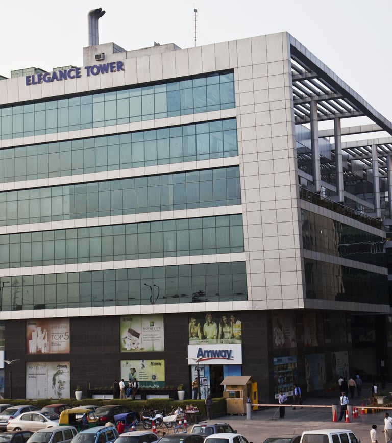 a large building with a lot of cars parked in front of it with elegance tower written on top
