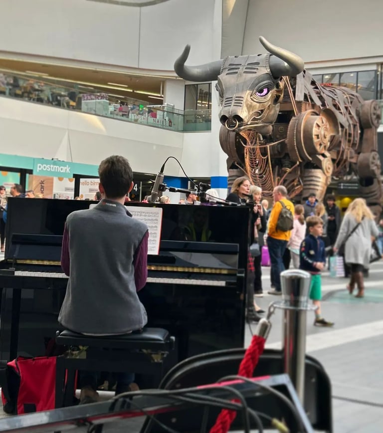 David Rice playing piano at Birmingham New Street Station