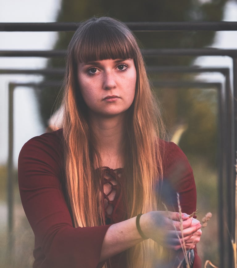a woman in a red dress sitting under bicycle stands