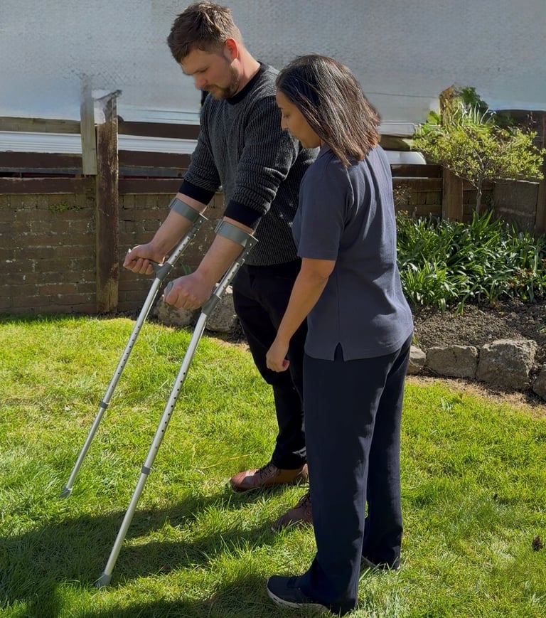 Home visiting physiotherapist in Cowbridge guiding patient during rehabilitation at home
