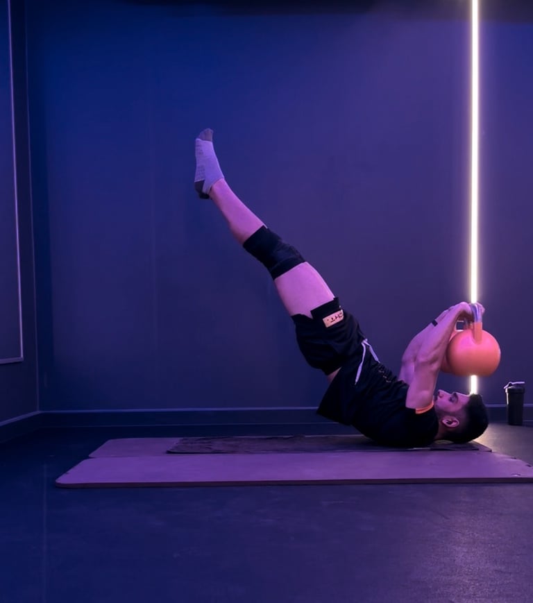 A man doing a dragon flag with bells. Calisthenics.