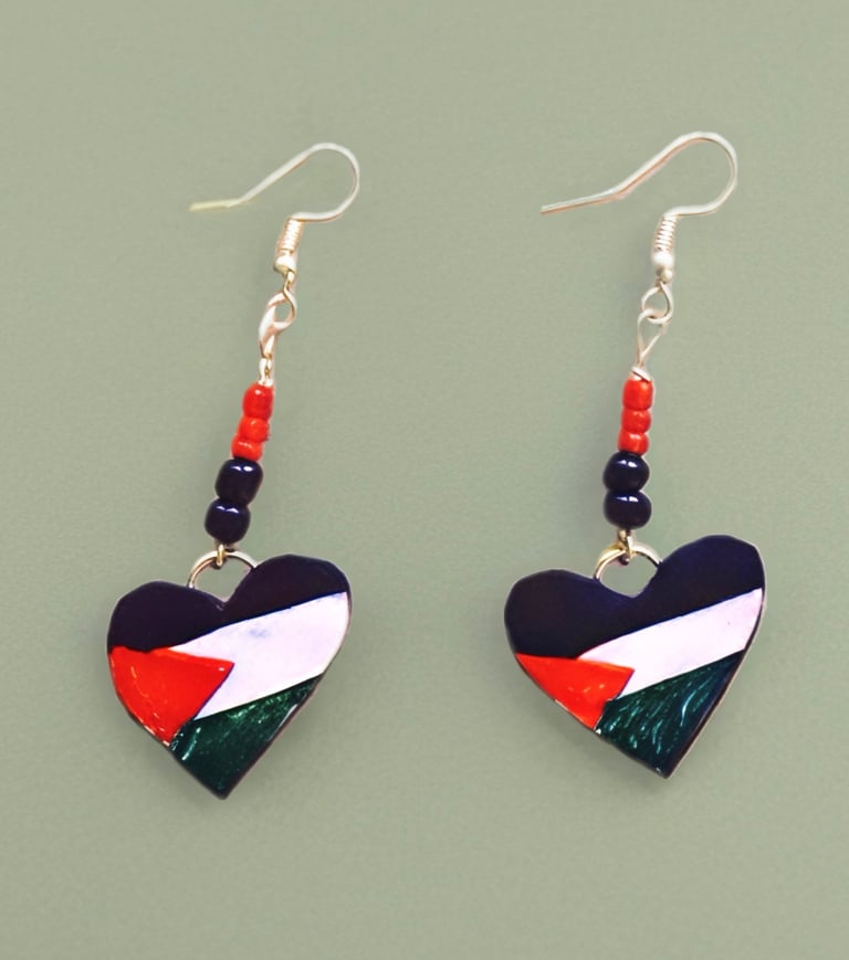 dangle earrings with red and black beads and heart charms of the Palestinian flag