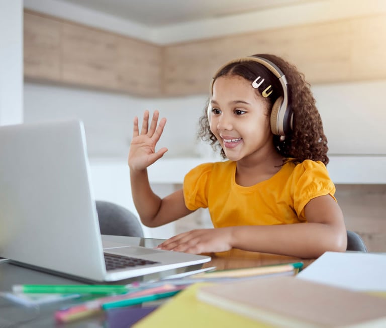 a young girl with headphones and a laptop waving hand