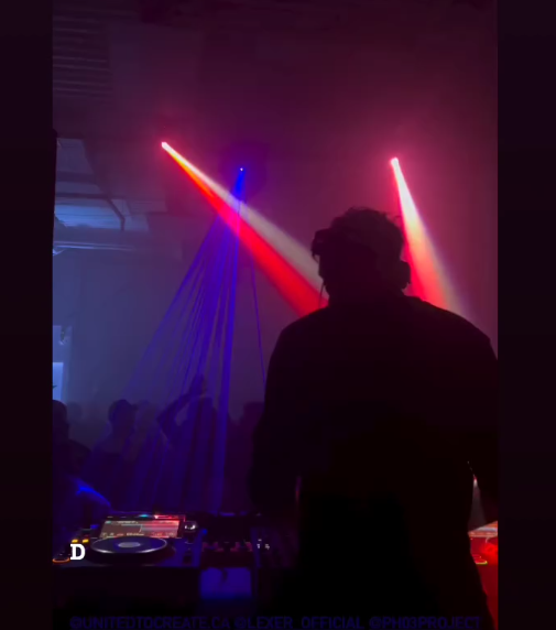 Silhouette of a DJ performing at a warehouse party with vibrant red and blue laser lighting effects.