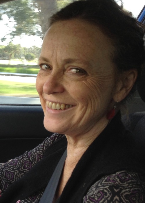 a woman in a car smiling at the camera