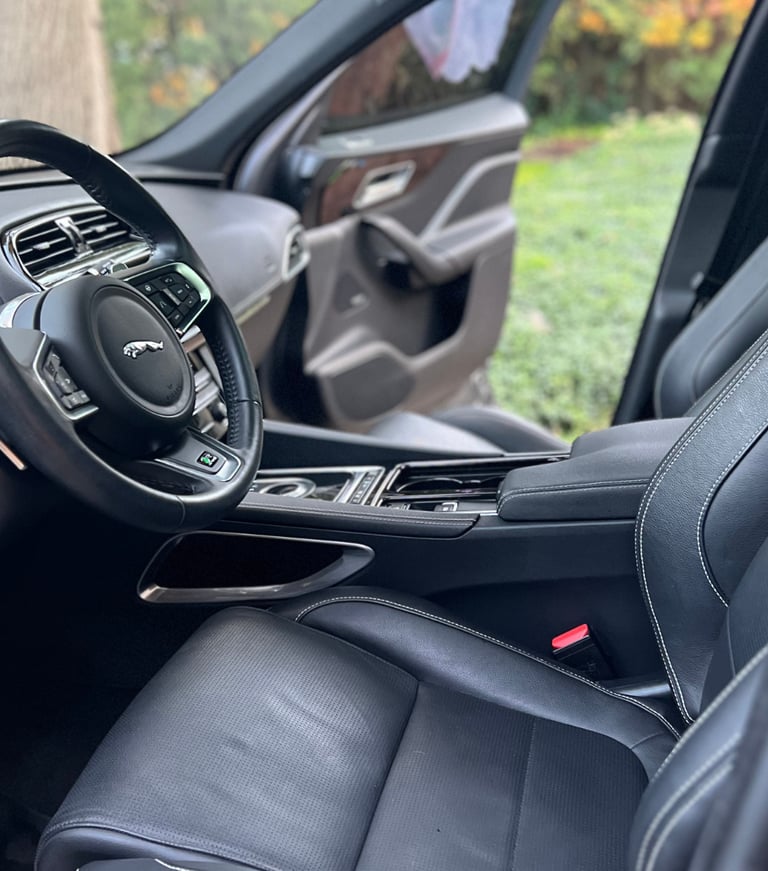 Sanitized SUV interior with clean cupholders and debris-free console