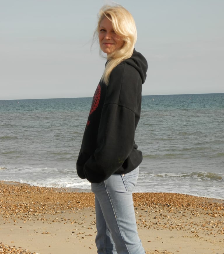 a artist woman standing on a beach 
