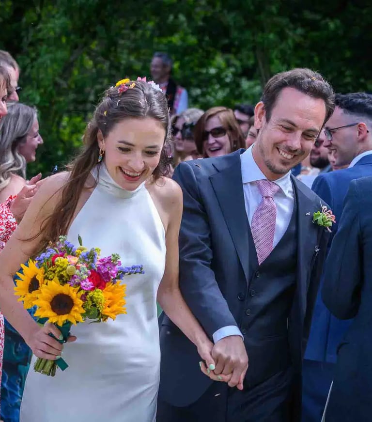a bride and groom walking down the aisle at a wedding