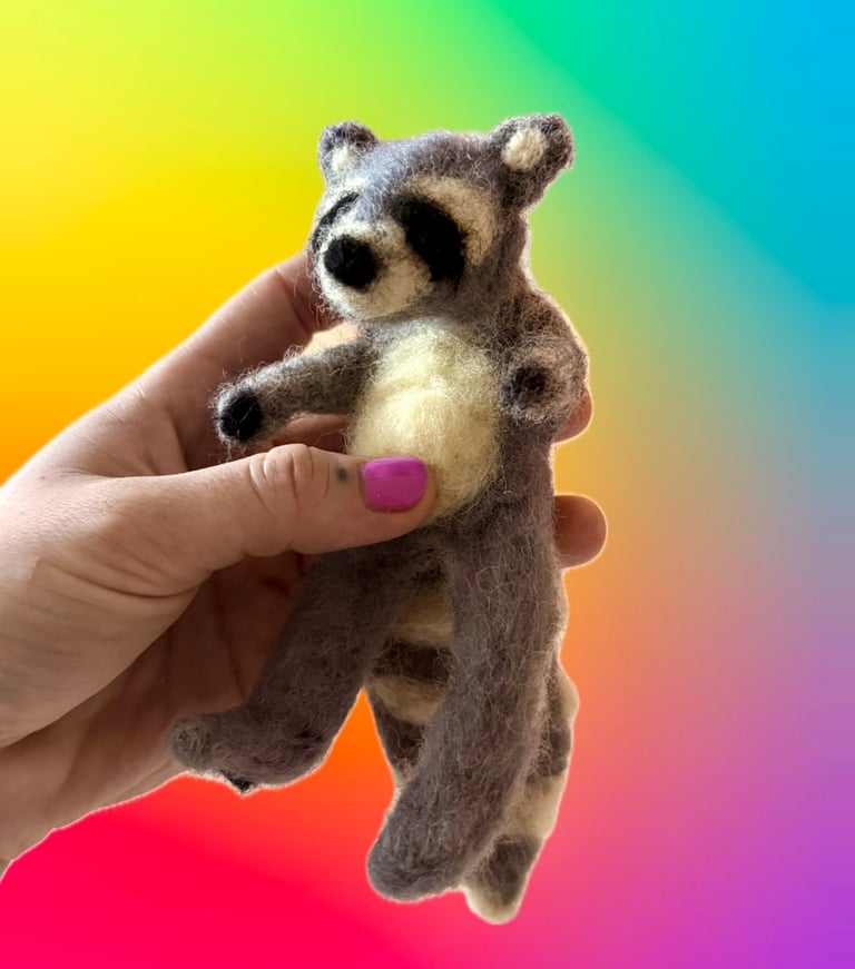 hand-felted raccoon sculpture made of raw fibers