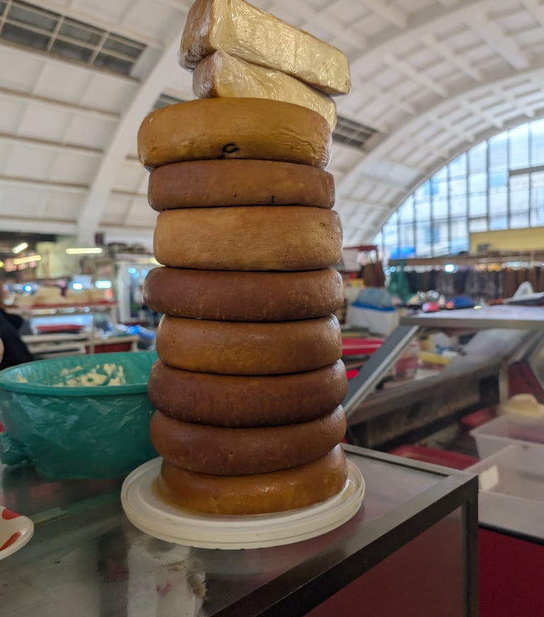 stacked smoked cheese wheels in the Green Bazaar in Kutaisi Georgia 