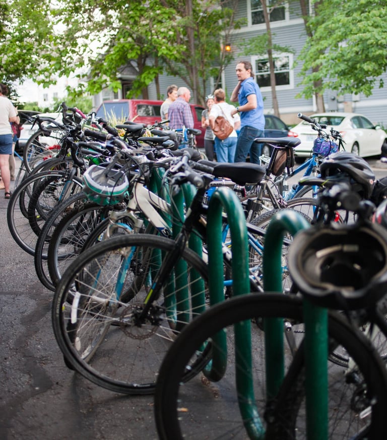 A full row of bikes on a long bike rack