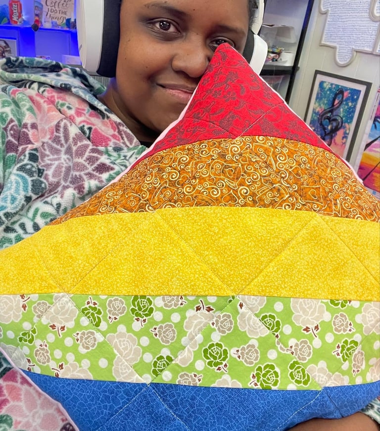 a woman holding a colorful pillow that has a rainbow - colored rainbow - colored pillow