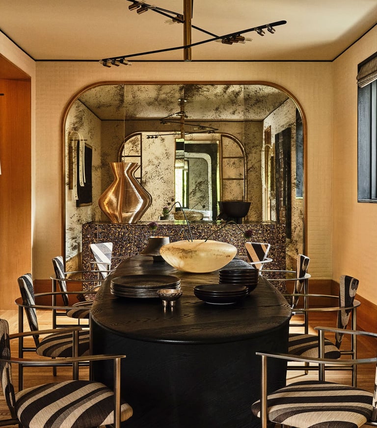 Kelly Wearstler design- dining room with a table and chairs.