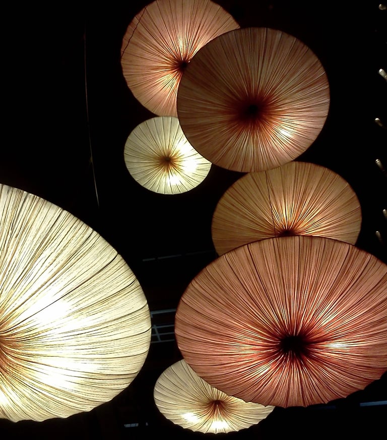 a bunch of umbrellas hanging from a ceiling
