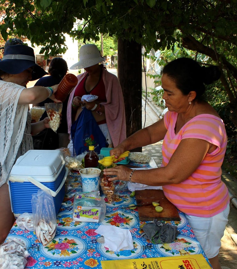a woman is preparing to serve fruit to the tourists