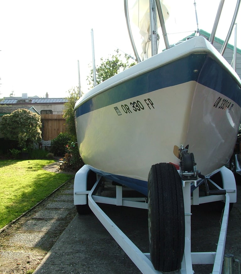 a boat sitting on a trailer trailer with a trailer attached to it