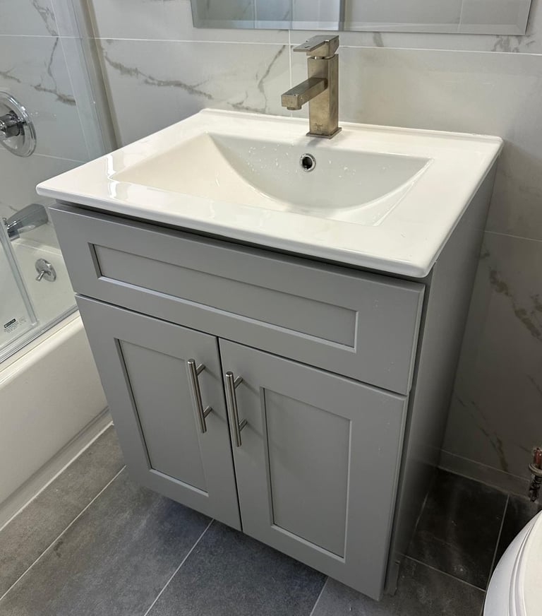 a bathroom sink with a white sink and a shower