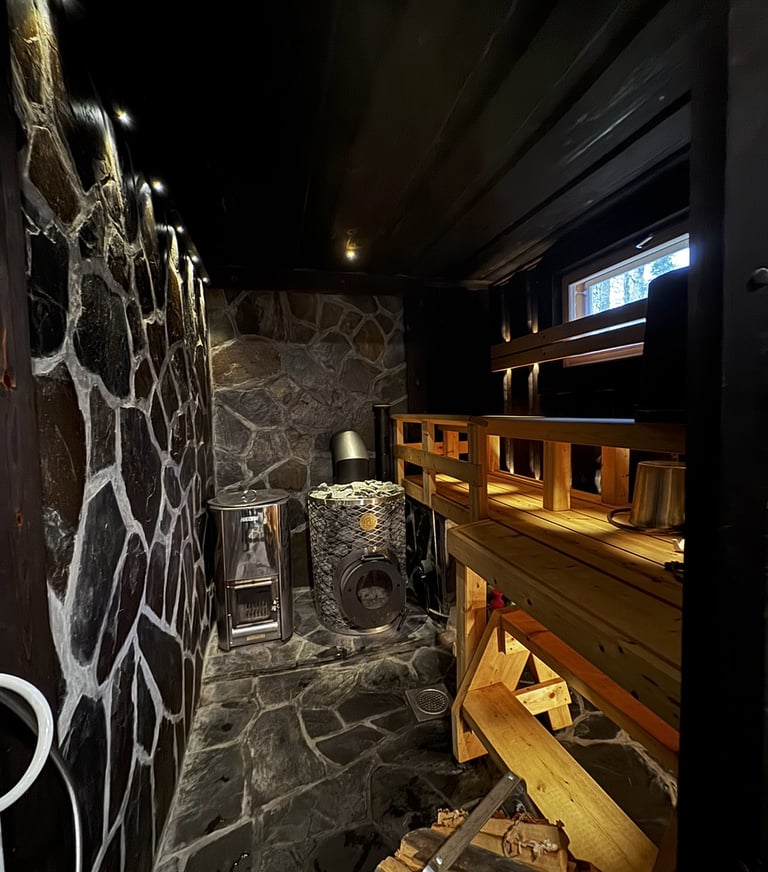 Rustic sauna, with slate masonery, and wide plank benches, iki kiuas