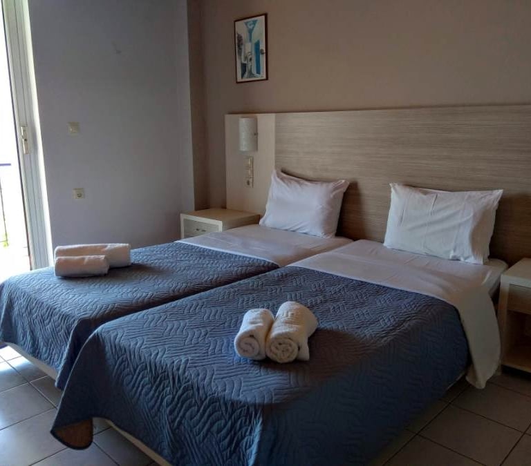 Delfini hotel room with two beds in a room with towels and towels