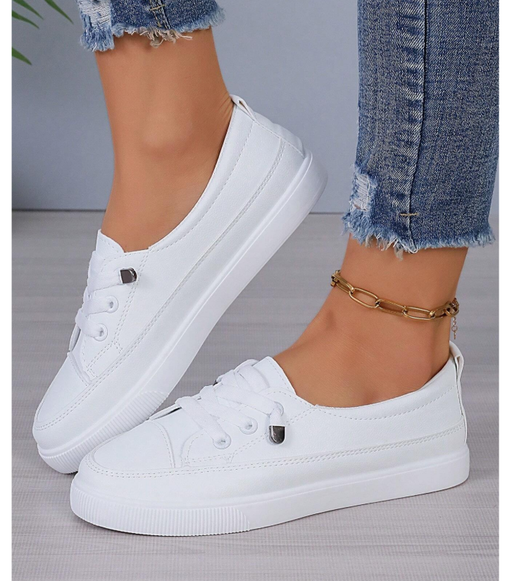 White lace-up fashion sneakers styled with maternity overalls.