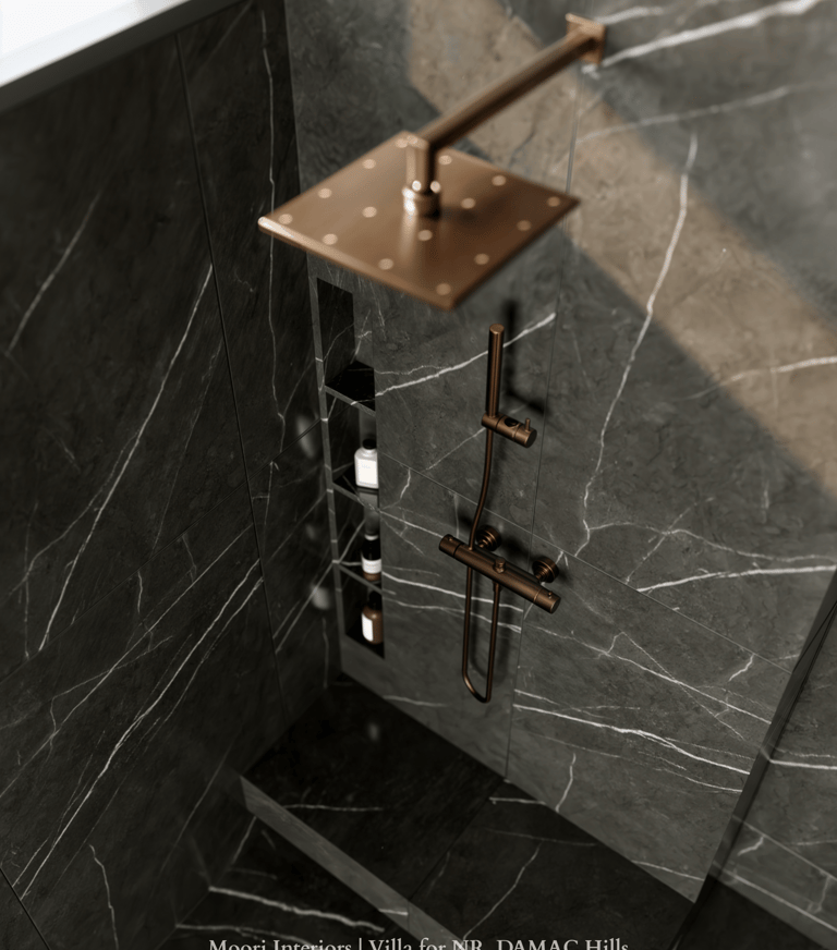 Luxurious shower detail featuring black marble shower walls with white veining and bronze fixtures