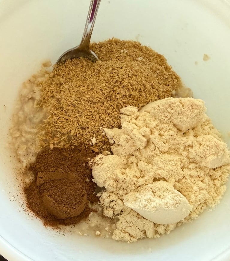 Oatmeal ingredients including protein powder, flaxseed, and cinnamon in a bowl.