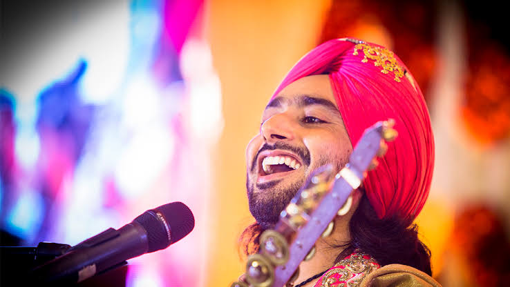 a man in a turban with a microphone and a microphone
