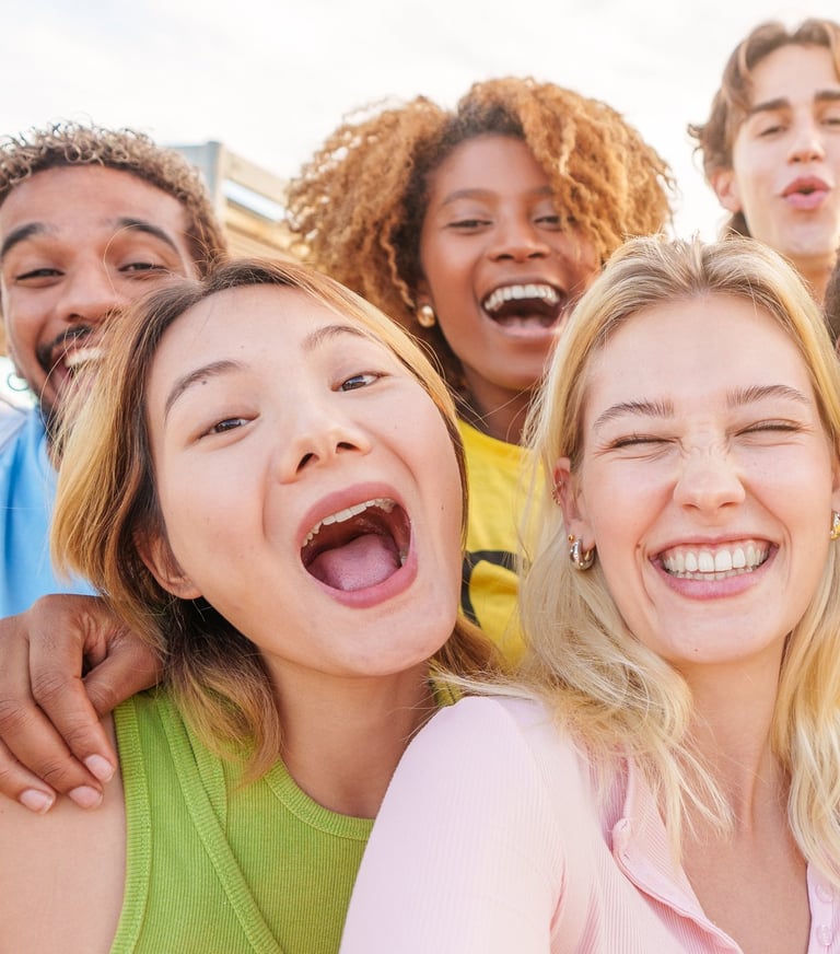 a group of people standing around a woman taking a selfie