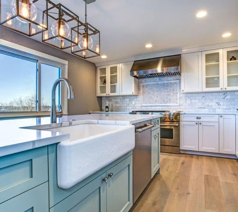 a kitchen with a sink and a large window, finished kitchen remodel