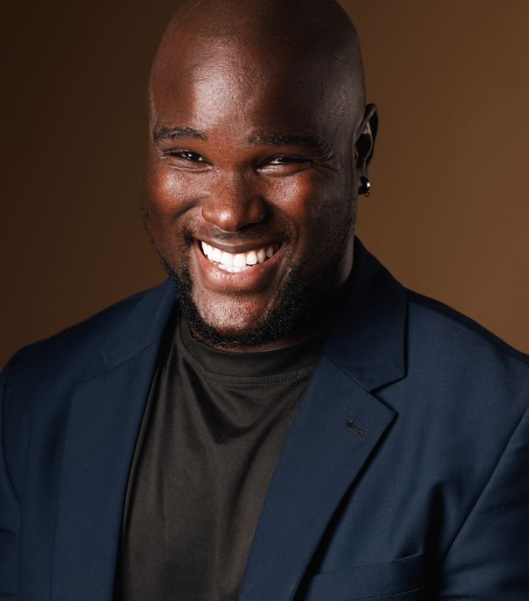 Smilling Bald Headshot Of Melvin Dain 