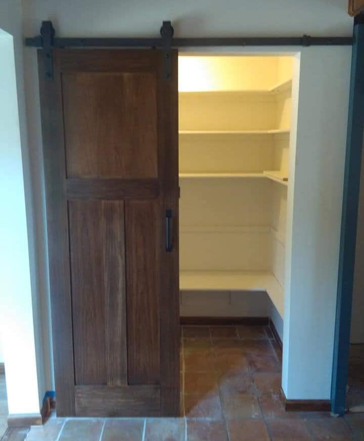 a door with a sliding door and a pantry