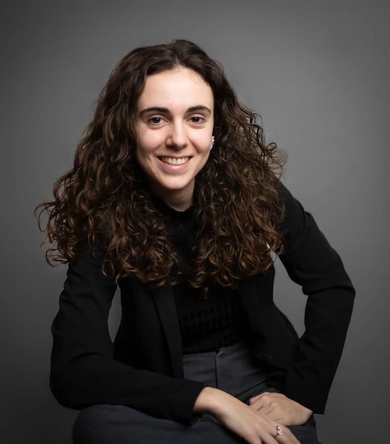 a woman with curly hair and a black jacket