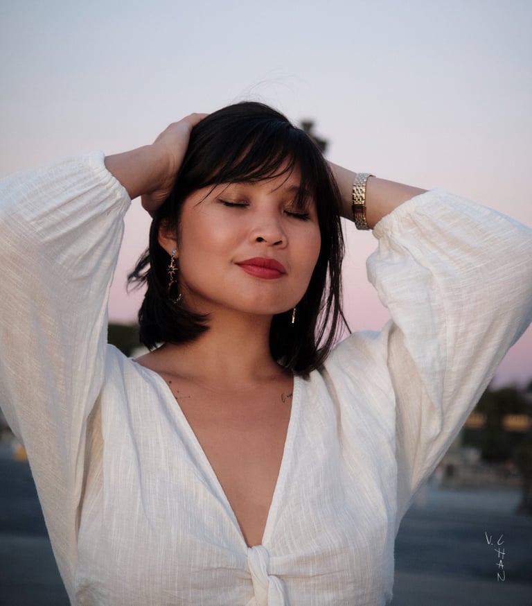Modèle femme brune avec une chemise blanche sur un fond de ciel le soir