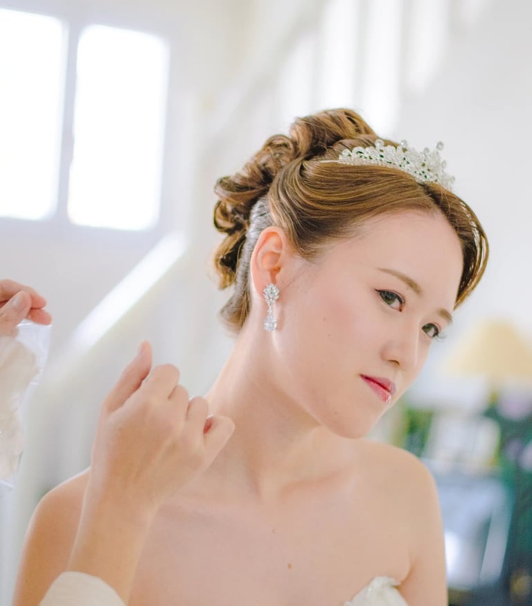 a woman in a wedding dress is wearing a tiablet