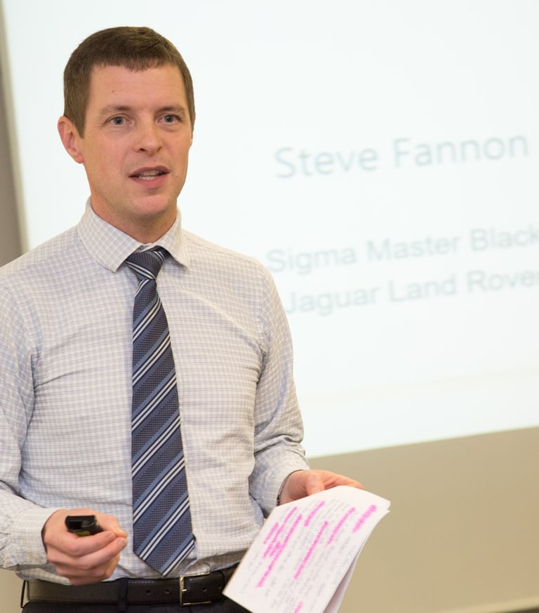 Steve Fannon presenting to a dinner audience in a previous role and organisation.
