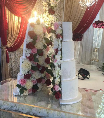 spilt wedding cake with roses in the middle 