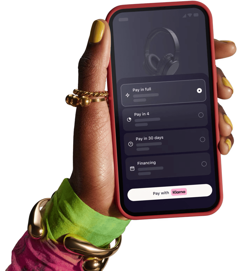 klarna interest free payments a person holding a cell phone with a cell phone in their hand