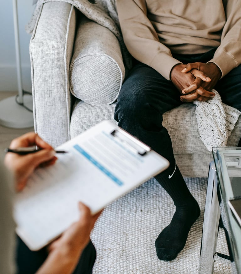 man sits on sofa in a consultation