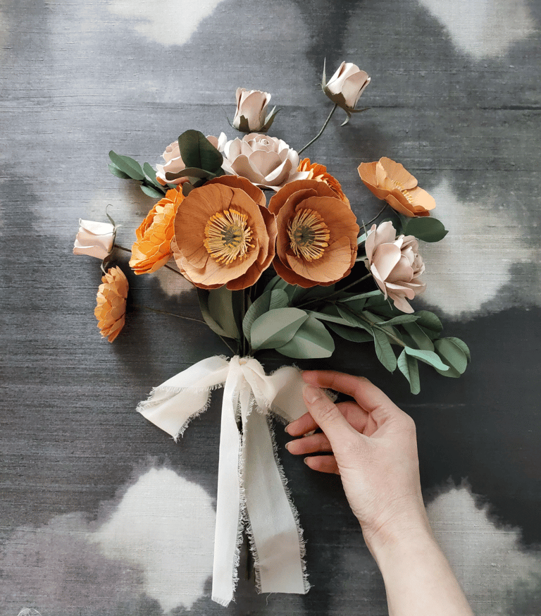 a person holding a bouquet of flowers in their hand