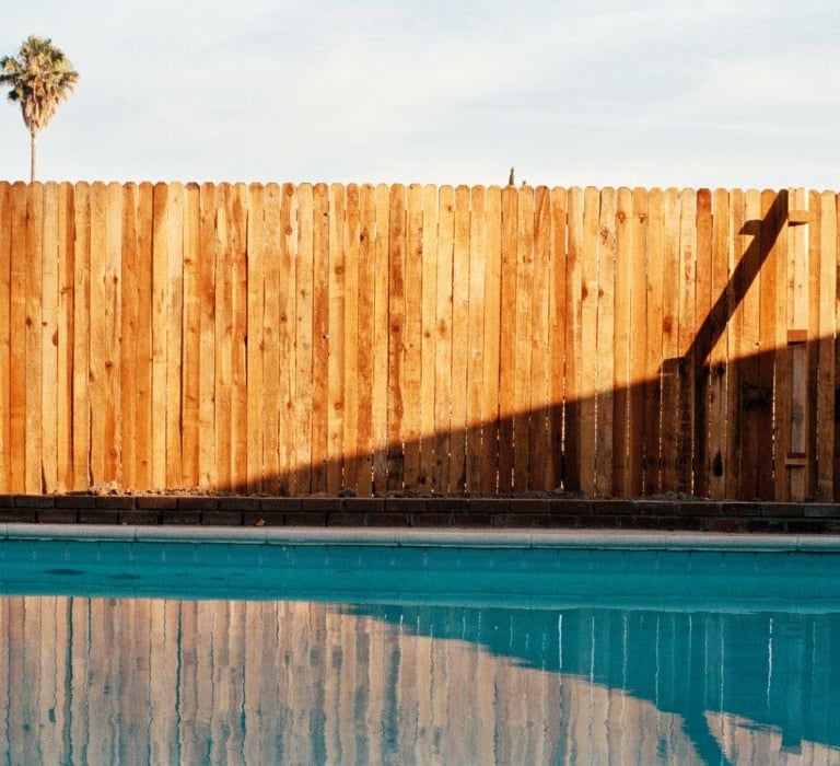 a wooden fenced in pool