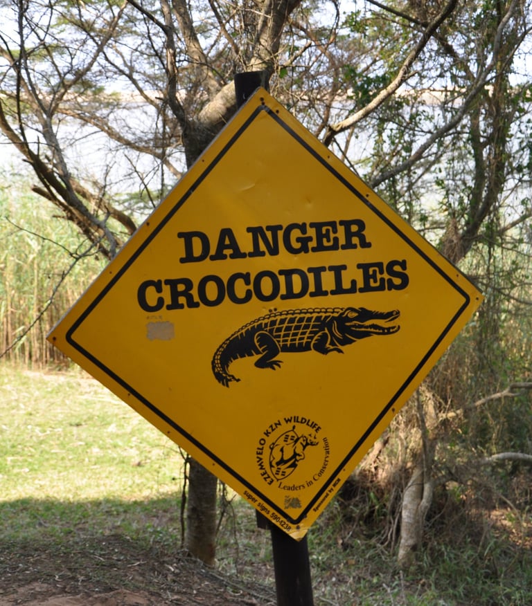 danger crocodiles sign at estuary beach, St Lucia, South Africa
